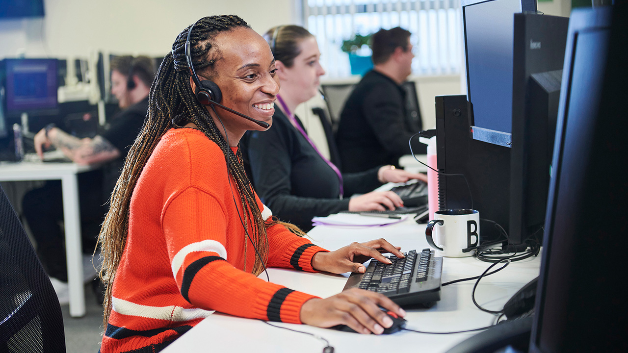 A call centre working smiling while on call