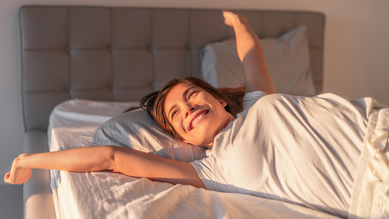 a person stretching in bed