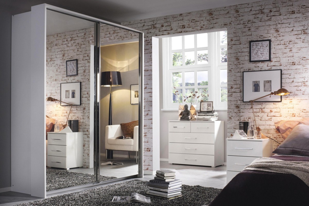 A sliding mirrored wardrobe set in an industrial feel bedroom