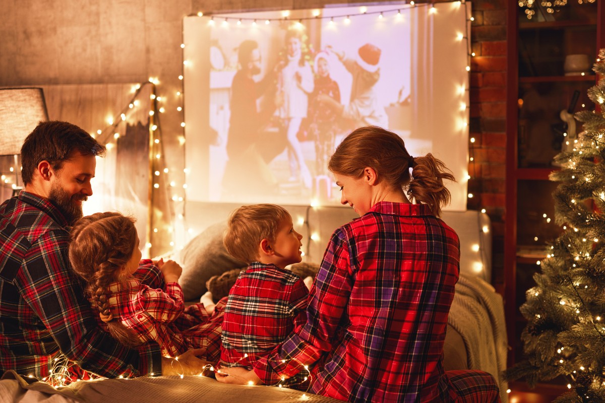 A family at Christmas enjoying a festive family film together