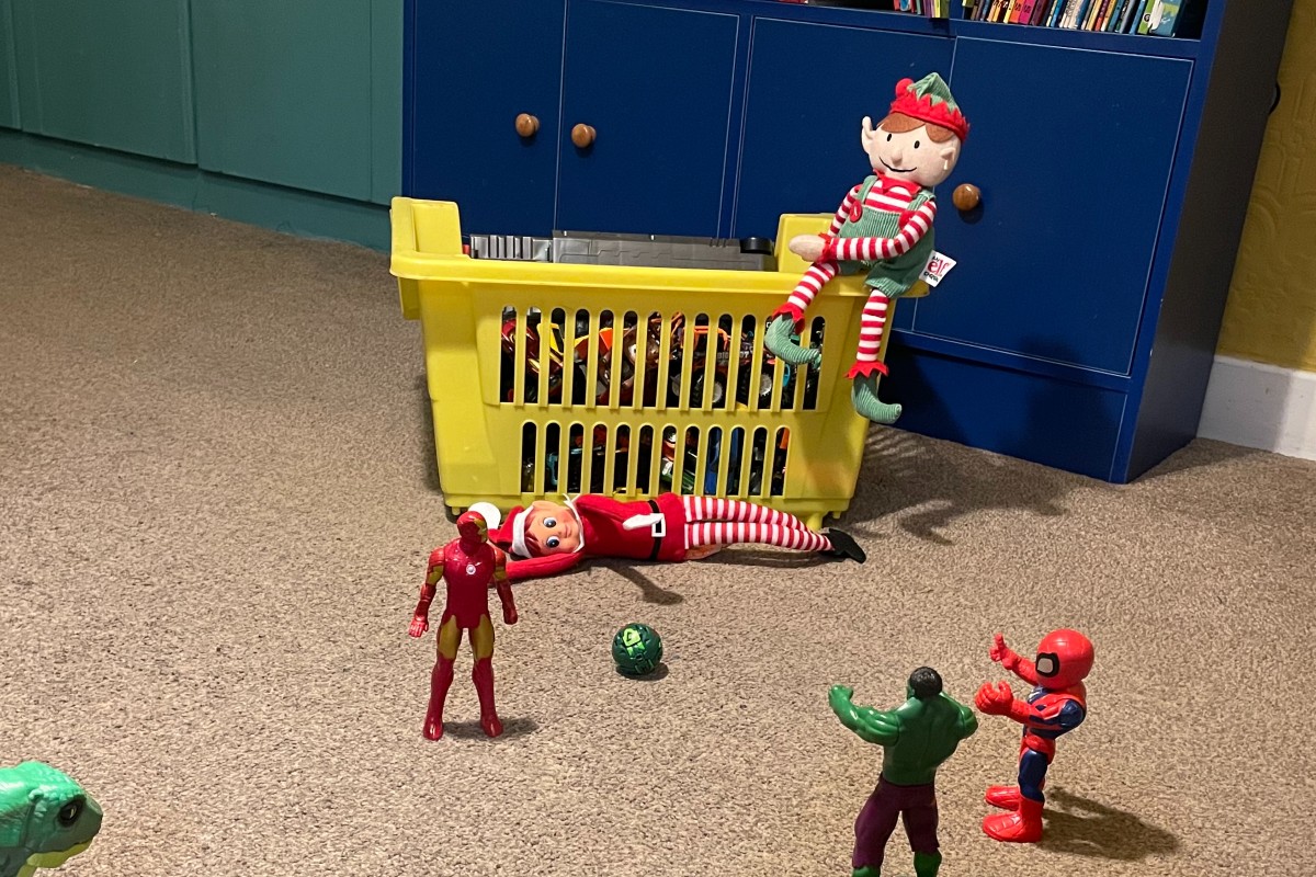 Elf on the shelf playing a footy match with a team of toys