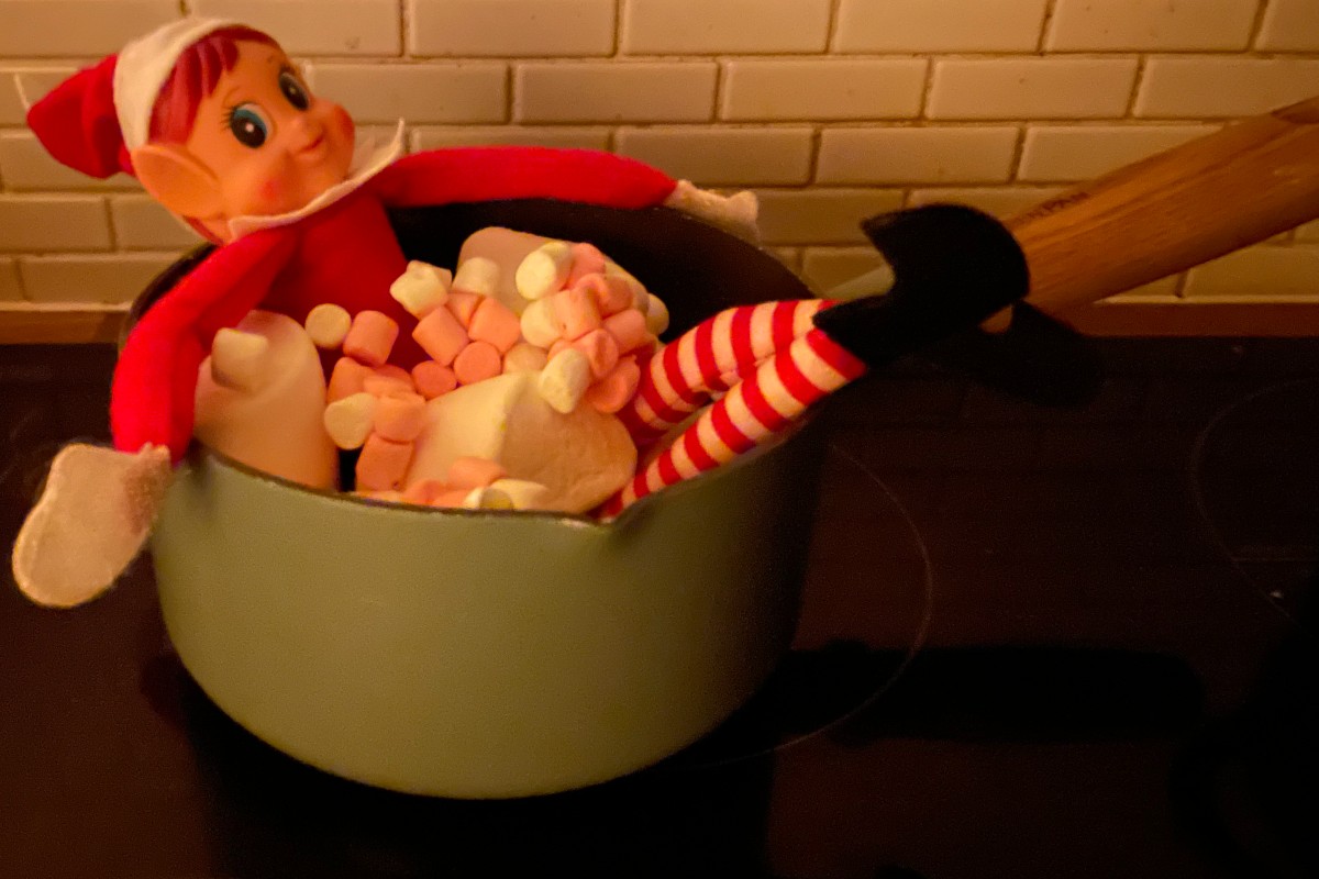 Elf on the Shelf taking a bubble bath in a pan of marshmallows