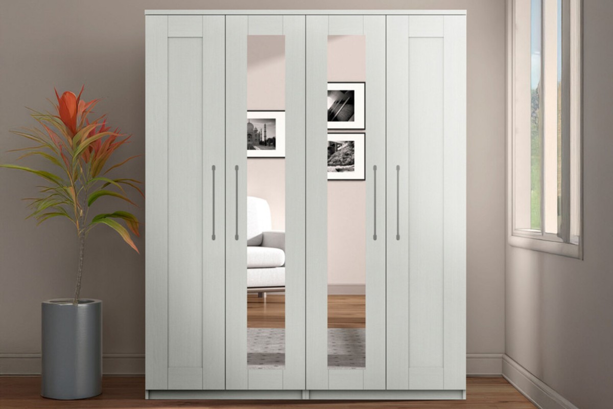 A white freestanding wardrobe with mirrored panels