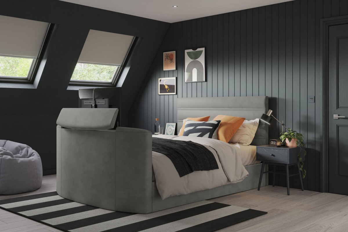 A light grey bed set in a charcoal grey panelled bedroom