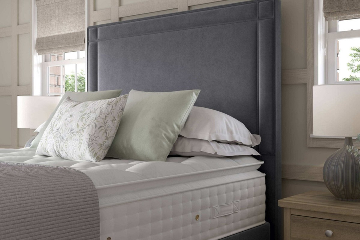 A stylish grey hotel height headboard with mirrors either side of the bed to mimic what you would usually see in a luxury hotel