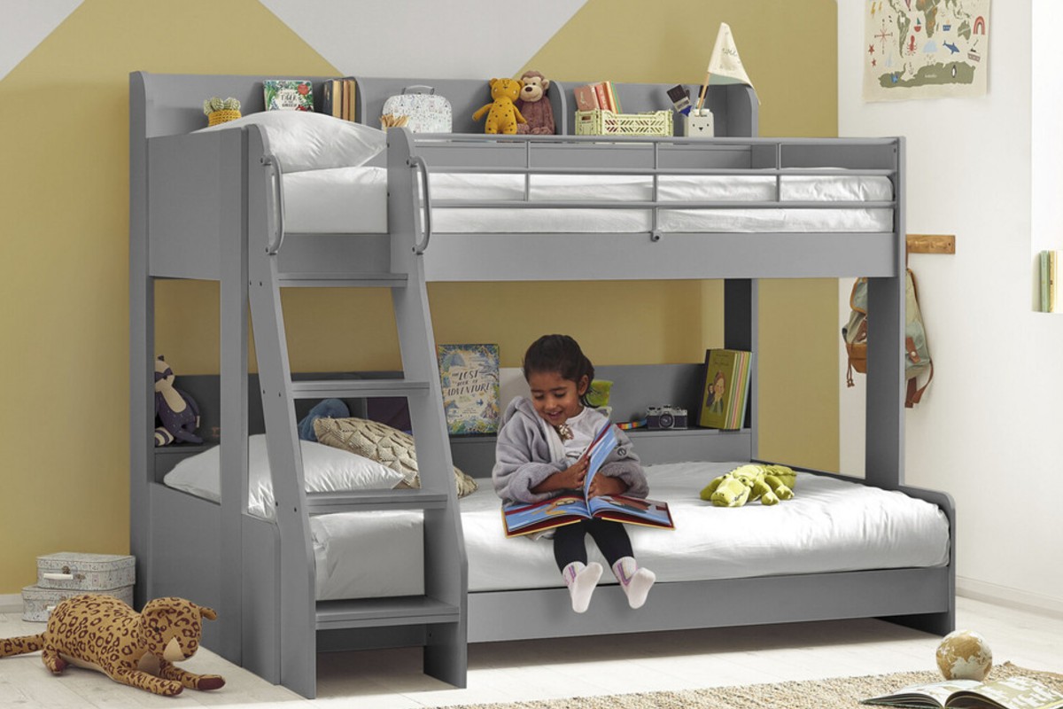 a cosy kids’ bedroom with a modern grey bunk bed and a child reading on the bottom bunk