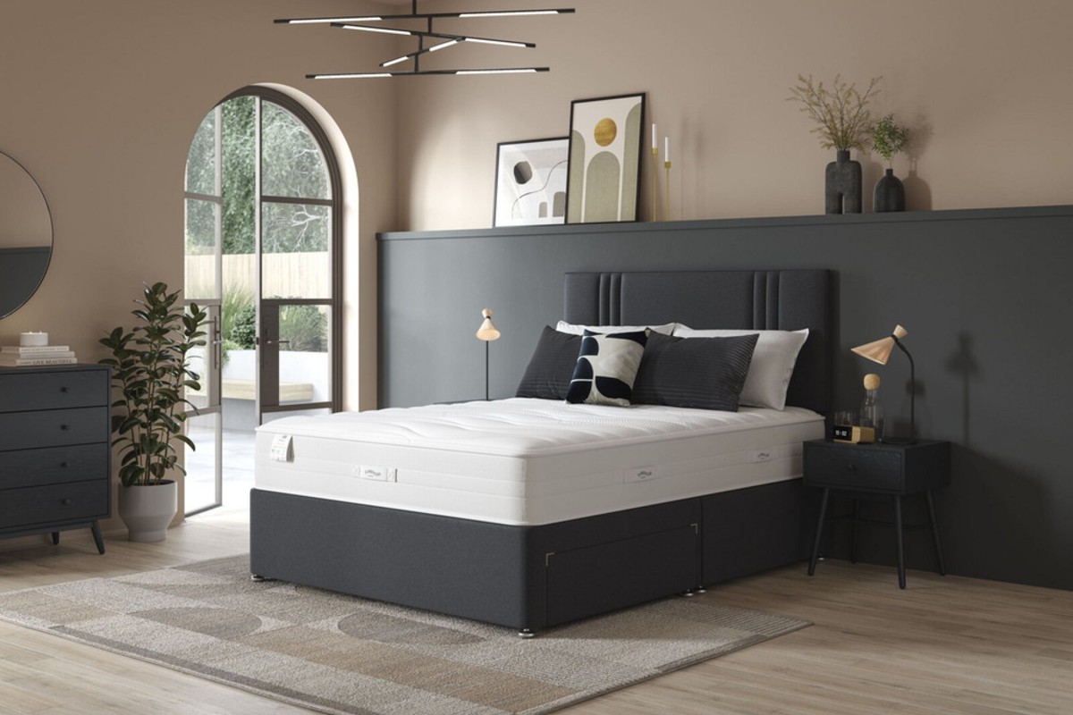 A small double divan bed set, making up the centrepiece of a contemporary bedroom design