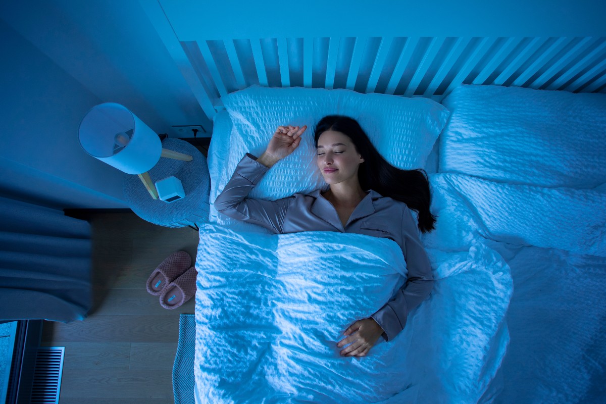 A woman asleep on her back in bed