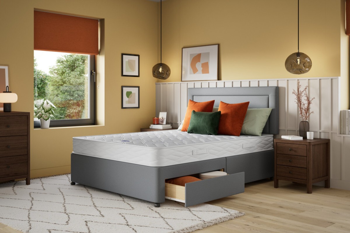 A bedroom painted in a warm yellow colour showcasing the striking combination grey and yellow makes